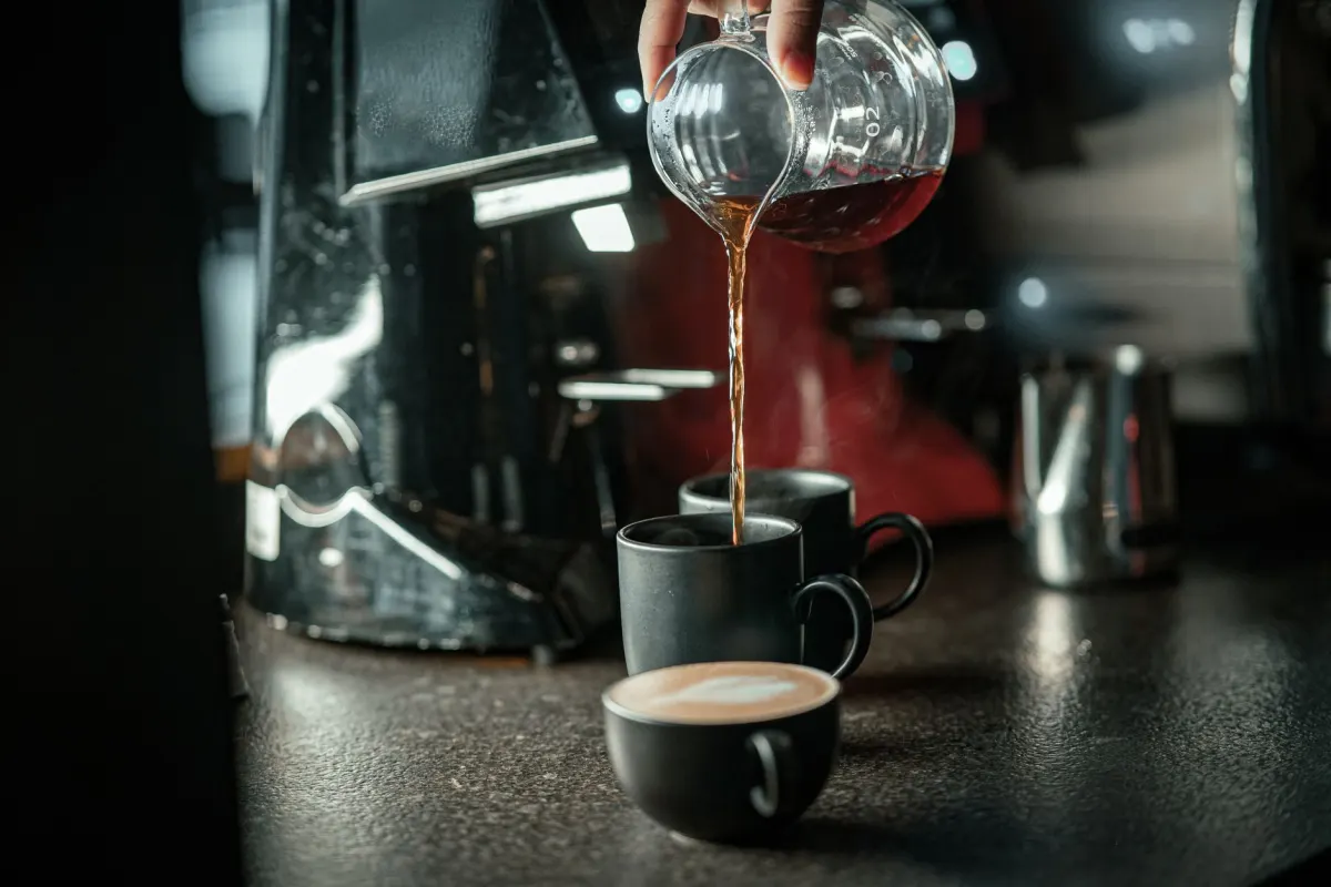 Ein Barista filmt eine Pour-over-Technik mit einem Handy-Stativ, die Art von Kurzclip, die als Reel gut funktioniert.