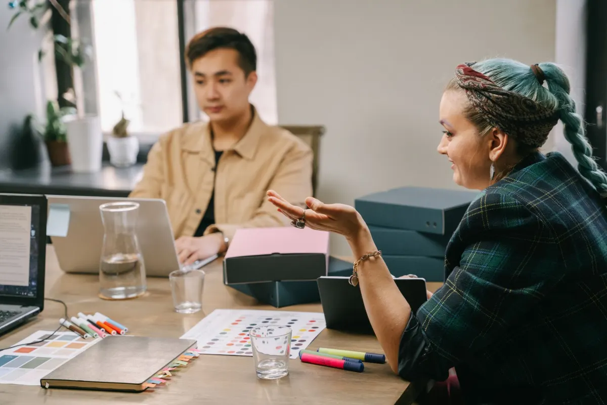 A marketing team gathers around a table to review client accounts, matching this section's focus on agencies.