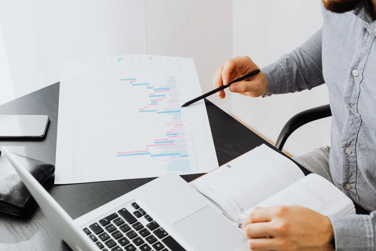 A marketer studies performance charts on a laptop to spot which content is working.