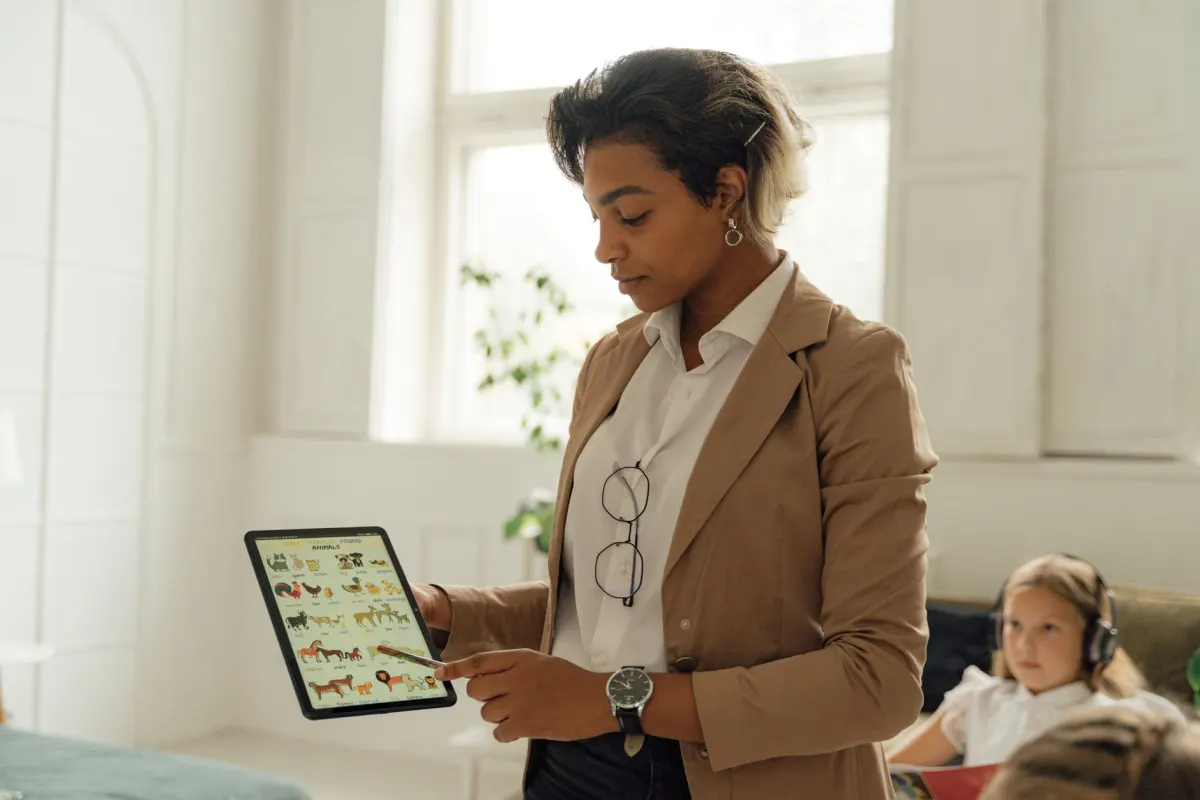 A student at a desk watching a short lesson on a tablet, illustrating how saved educational videos can serve as a study reference.