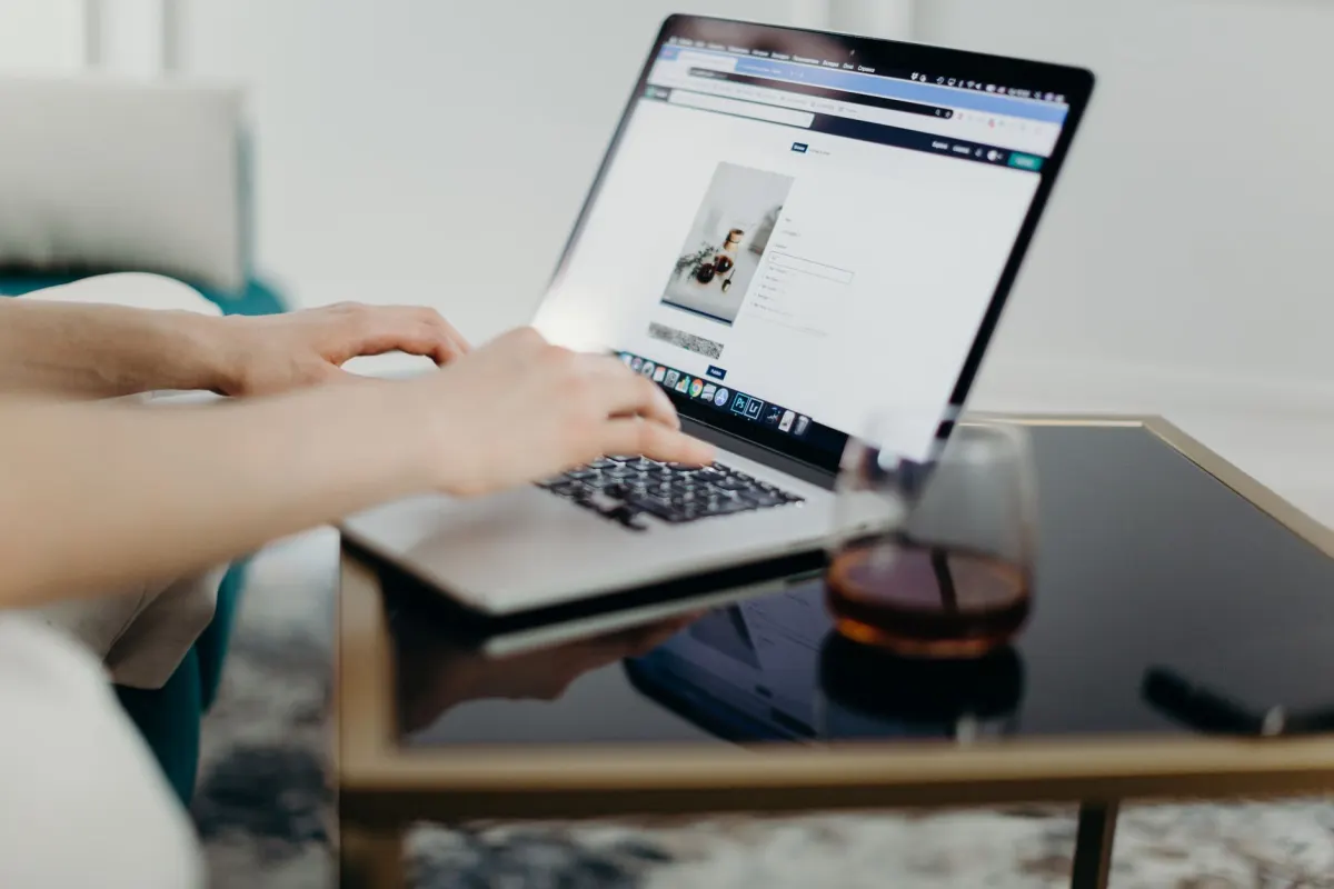 Eine Kreative lädt ein Video vom Laptop hoch, der Desktop-Schritt, den TikToks Planungsablauf verlangt.