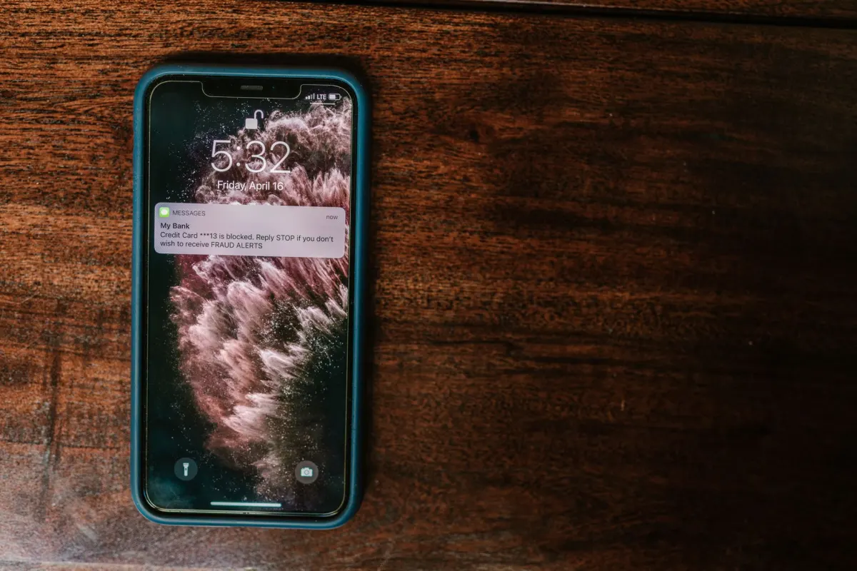 A smartphone screen showing a notification alert, illustrating how @ mentions notify tagged users.