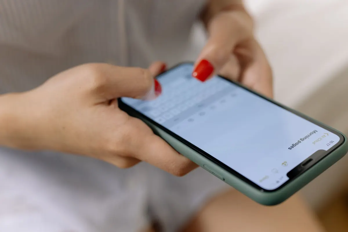Eine Person wischt über einen Kommentar auf dem Handy, die Aktion, mit der man jemanden direkt über einen Kommentar einschränken kann.