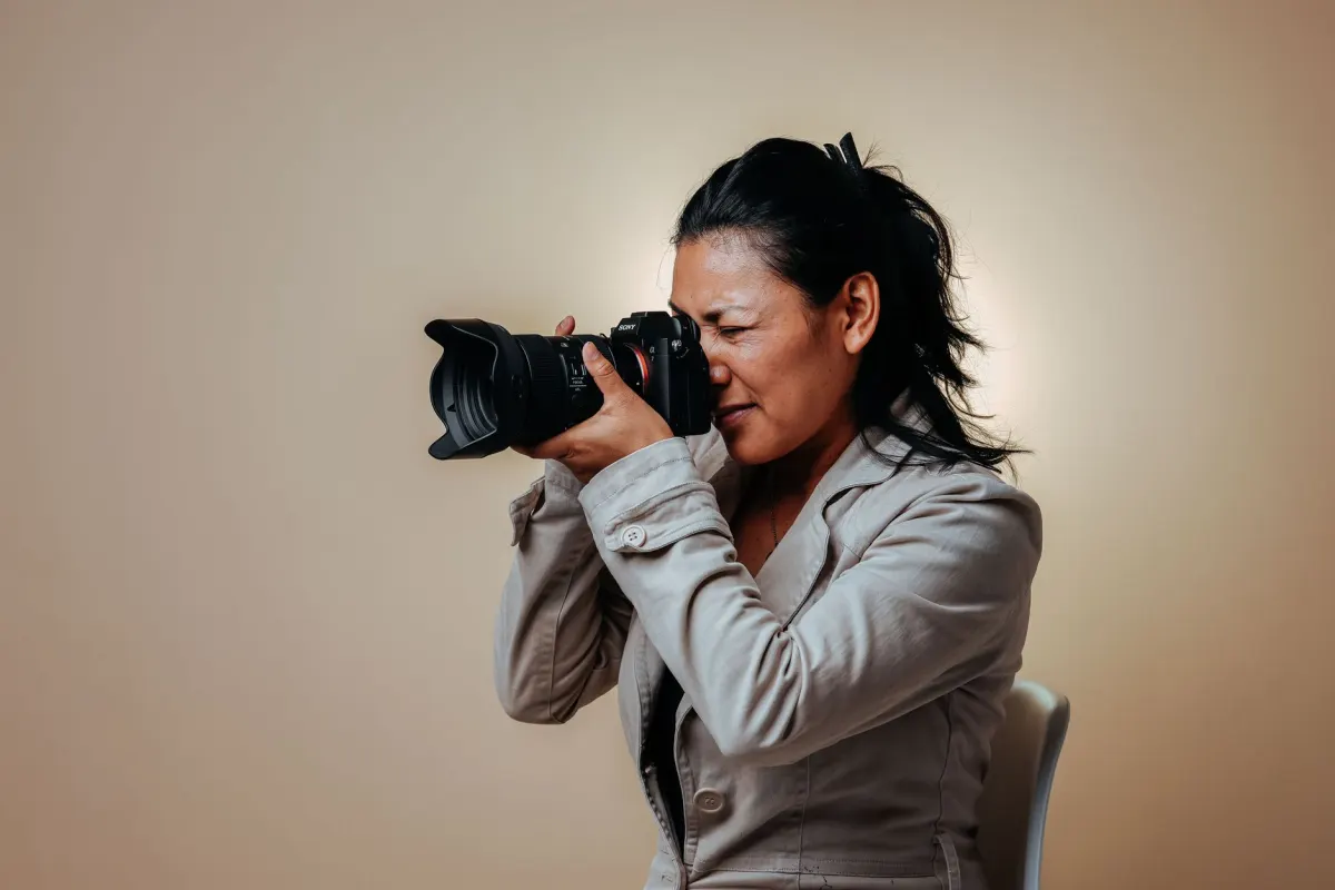 Ein Fotograf macht ein professionelles Porträtfoto, wie es für ein LinkedIn-Profilbild verwendet wird.