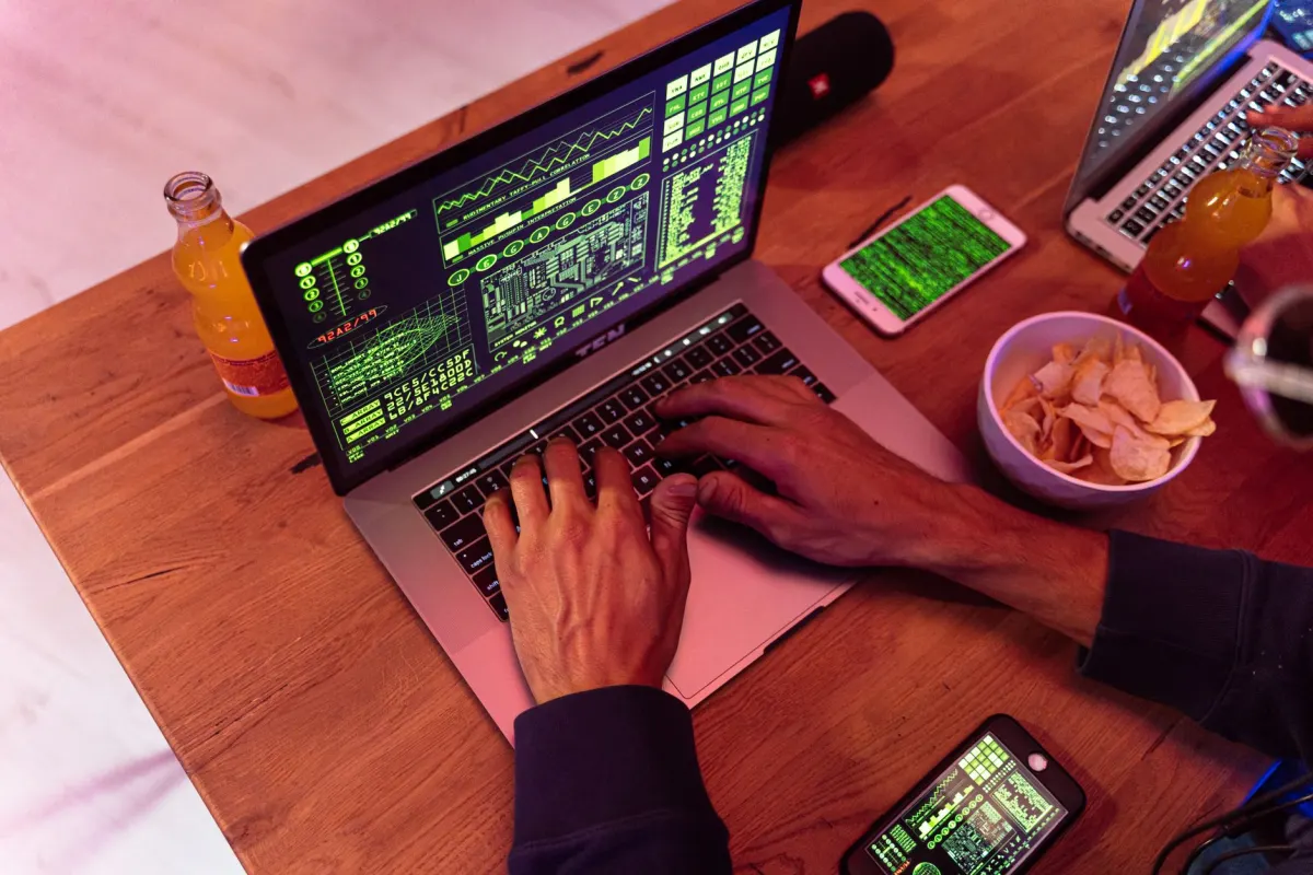 A person typing a password into a laptop at a desk, illustrating why an agent should not hold your Facebook login.