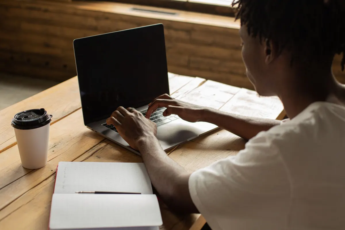 A person typing on a laptop, reflecting how each character typed into a post gets counted.