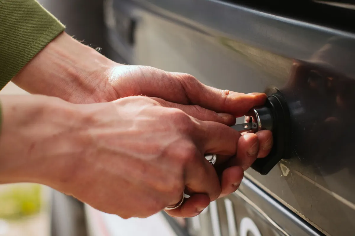 A hand turning a key in a door lock, illustrating why a sign-in is safer than handing over a secret token.