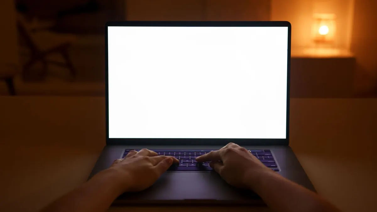 A person working at a laptop on a desk, standing in for the morning check of X connections and failed posts.
