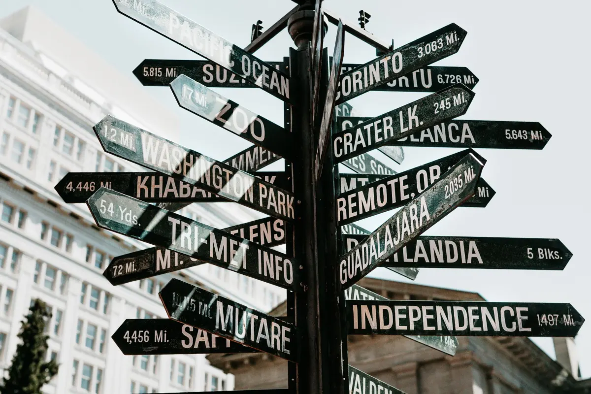 A road sign pointing in several directions represents the extra hops a platform link shim adds before a reader reaches the destination.