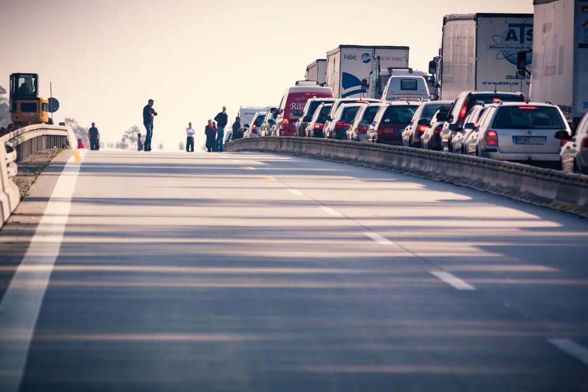 Rows of cars stuck in a traffic jam on a highway, a picture of a server turning away requests once too many arrive at once.
