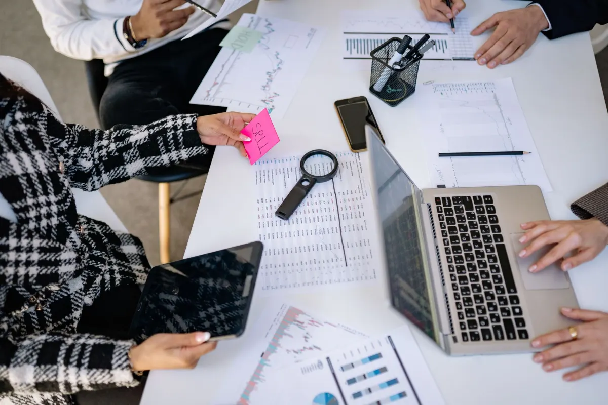 Ein Marketingteam prüft einen Content-Kalender auf einem Laptop, die Art von kollaborativer Planung, die Enterprise-Scheduling-Tools unterstützen.