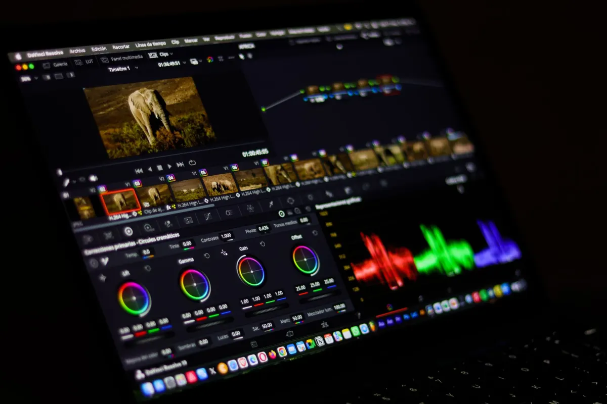 A video editor works on a laptop timeline, illustrating the process of adapting horizontal footage for a vertical feed.