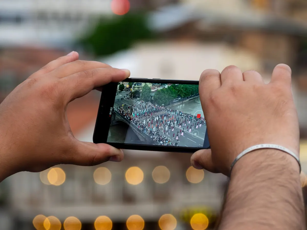 A phone displaying a video file mid-upload, representing the size and duration checks a media_category triggers.