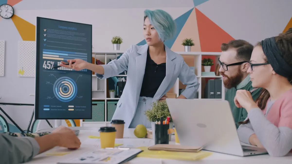 A team reviewing a video ad campaign on a laptop, tied to the separate size limits promoted video uploads face.