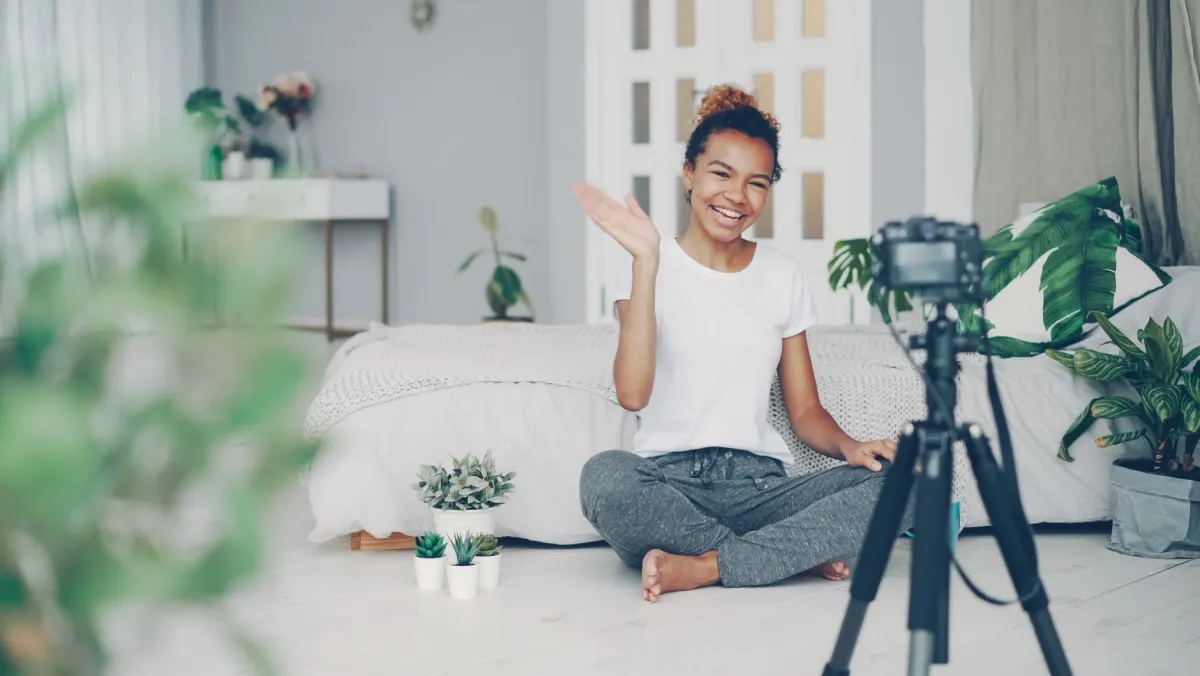 A creator sets up a phone on a tripod to film a short vertical video for social media.