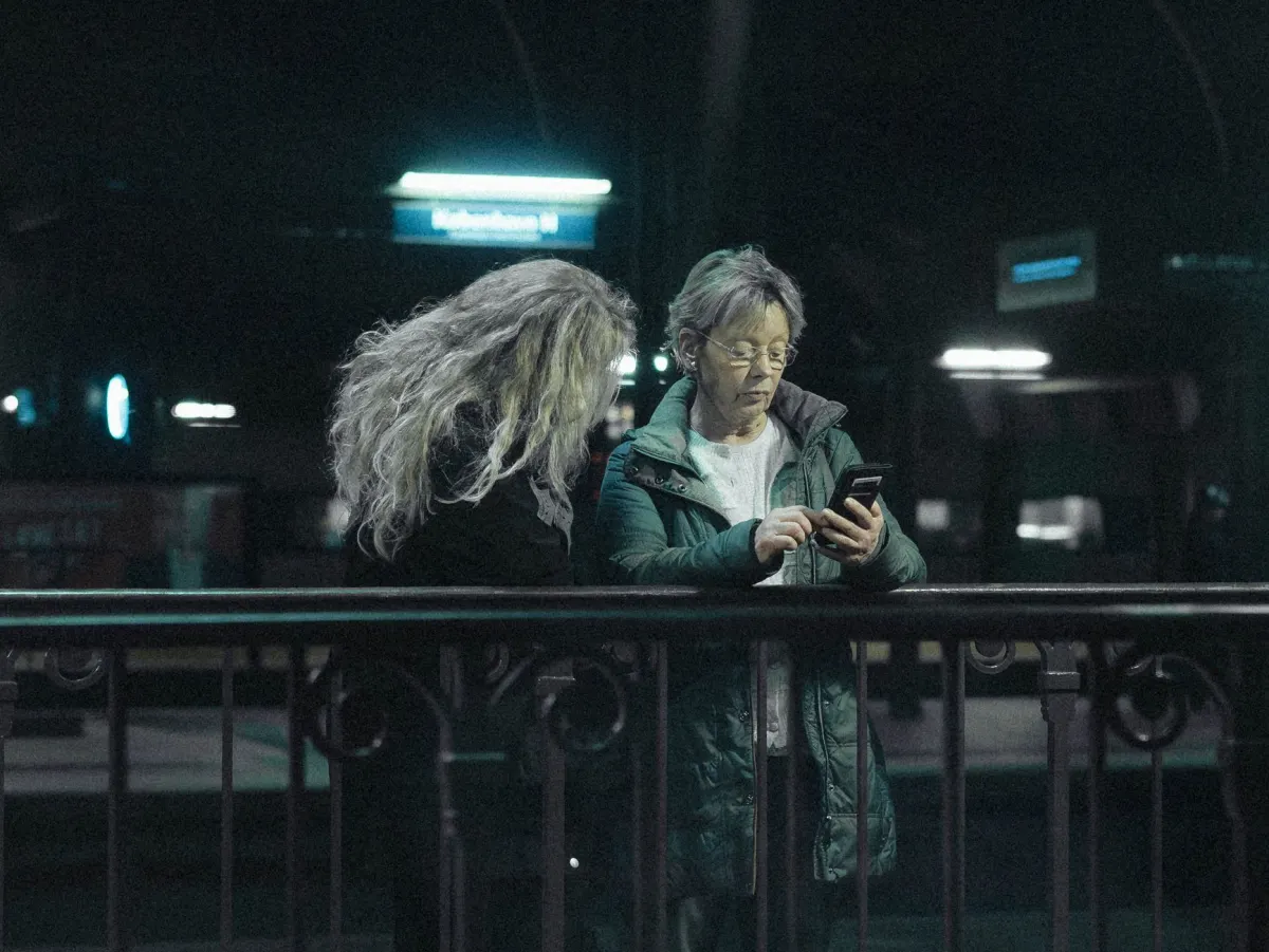 A person checks the time on their phone at night, echoing the risk of a scheduled publish time landing in the past.