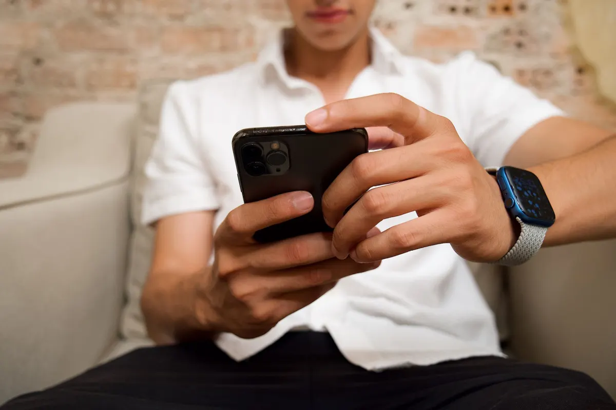 A person watching a video on a phone, since Google Ads defines an engaged view around how long someone keeps watching an ad.