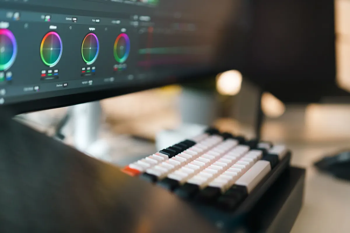 Video creator editing footage at a desk, the kind of batch work where a silent upload saves subscribers from a flood of alerts.