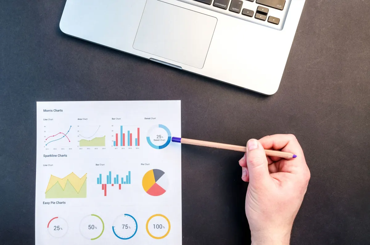 A person reviews cost and performance charts on a laptop, reflecting the comparison in this section.