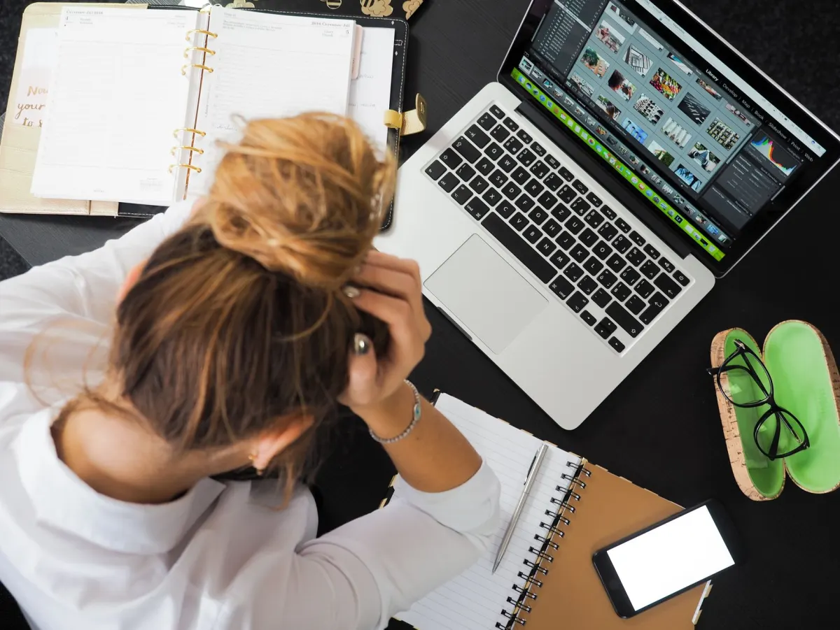 A developer frowning at a laptop, the kind of moment session replay is built to catch and route straight to a fix.