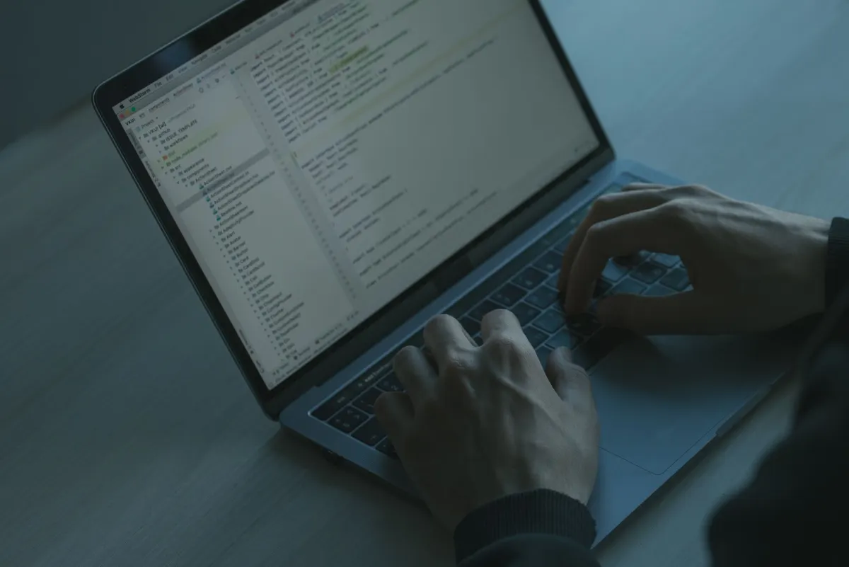 A developer working at a laptop, representing the privacy-conscious visitors that analytics tools often fail to count.