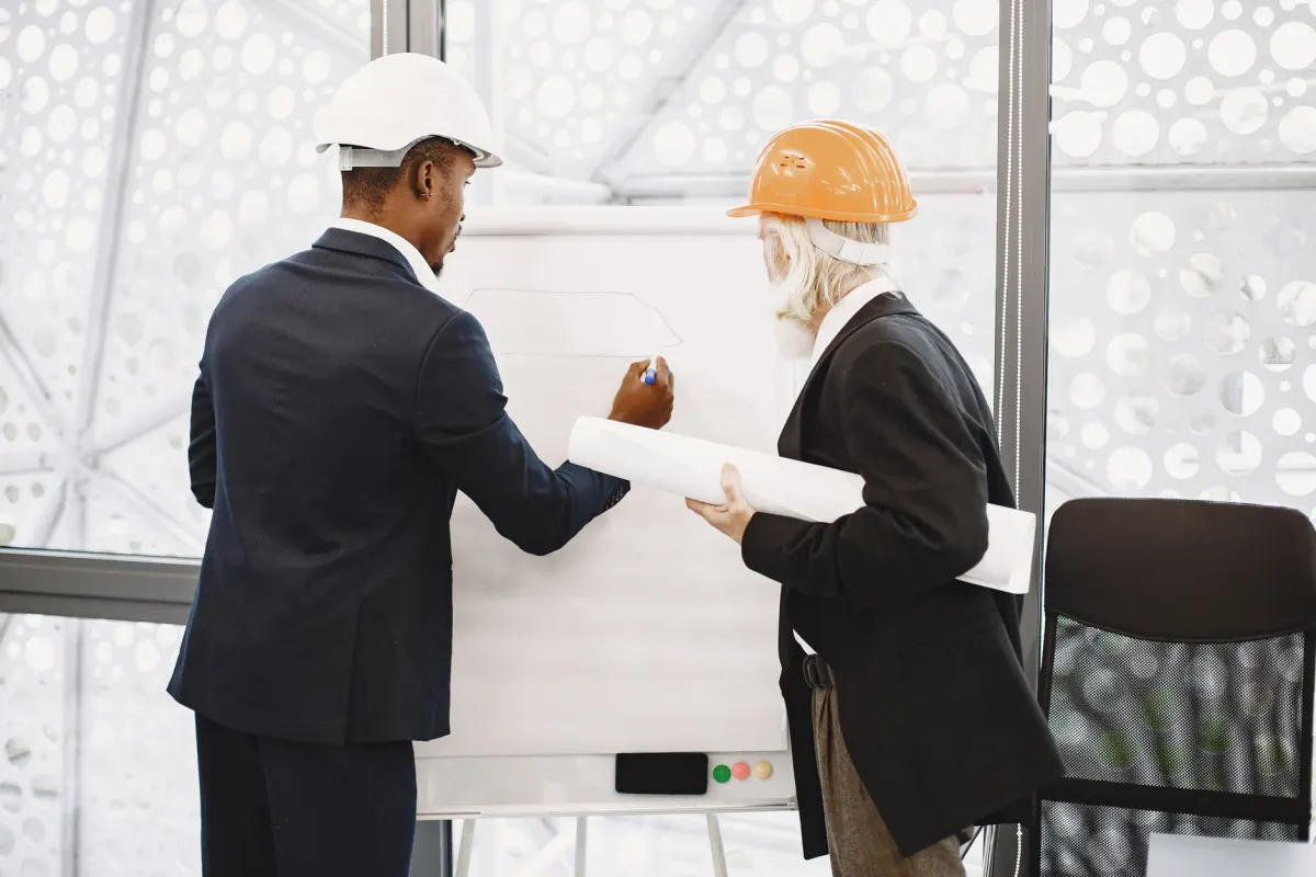 A team of engineers gathered around a whiteboard, matching this section on PostHog and engineering-led analytics workflows.