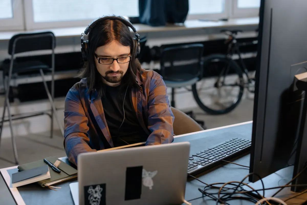 A developer works on a laptop in a small office, matching the developer-focused audience this section addresses.