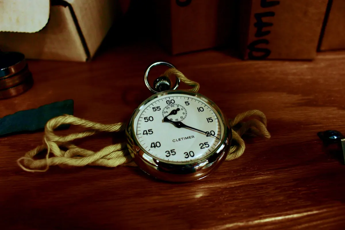 Un chronomètre posé sur un bureau, représentant les essais chronométrés et répétés sur lesquels repose une méthodologie de mesure fiable.