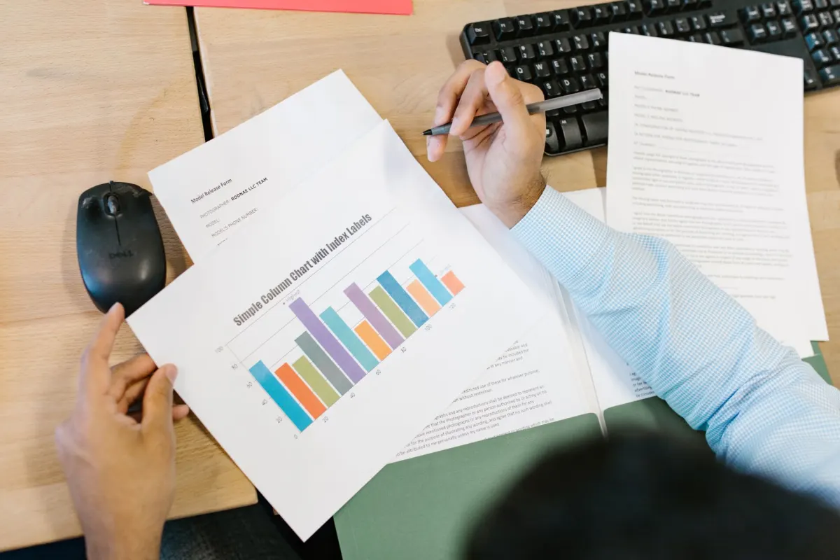 Two analysts compare charts on a monitor, the kind of side-by-side review that separates traffic data from behavior data.
