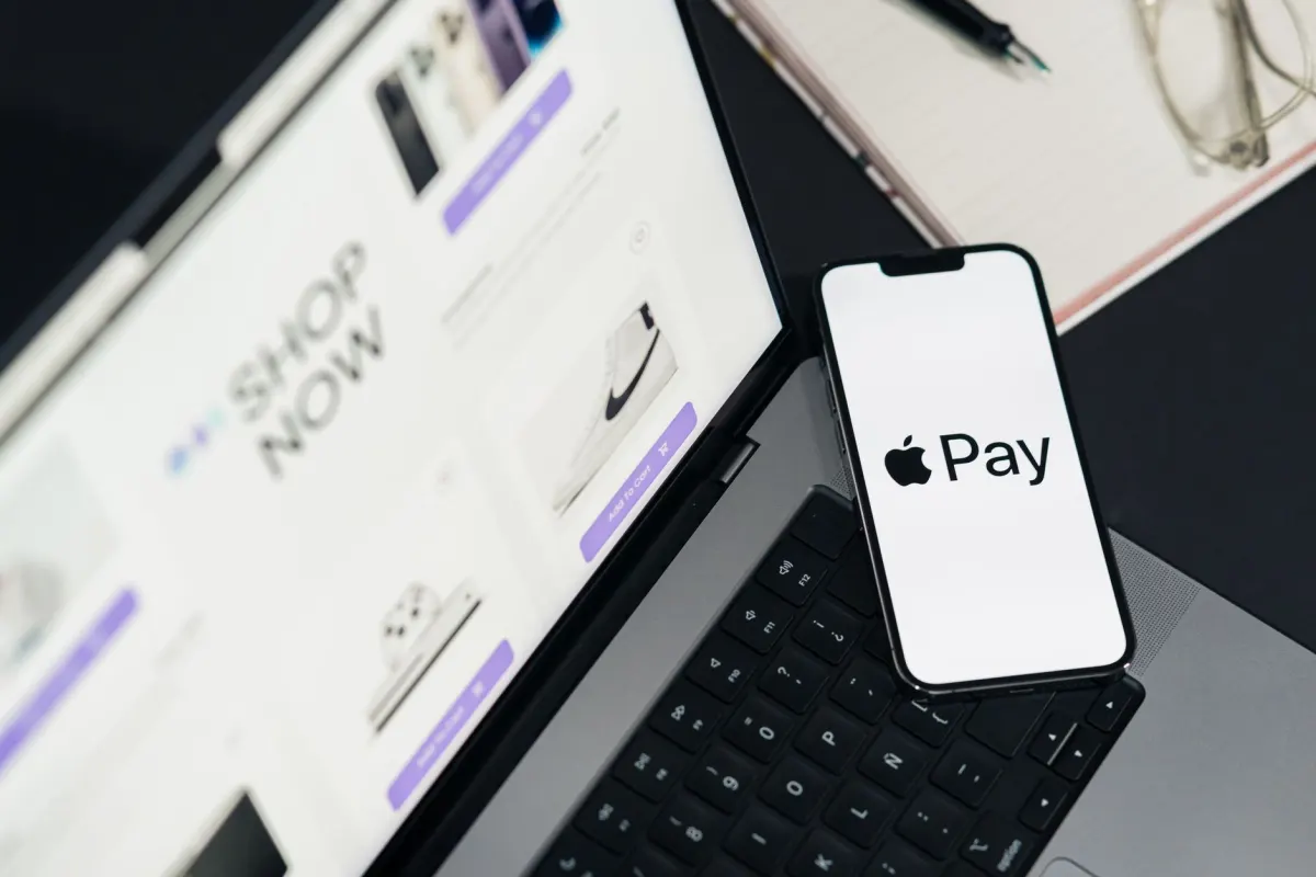 A shopper enters payment details on a laptop, the checkout moment that order and funnel tracking are built to capture.