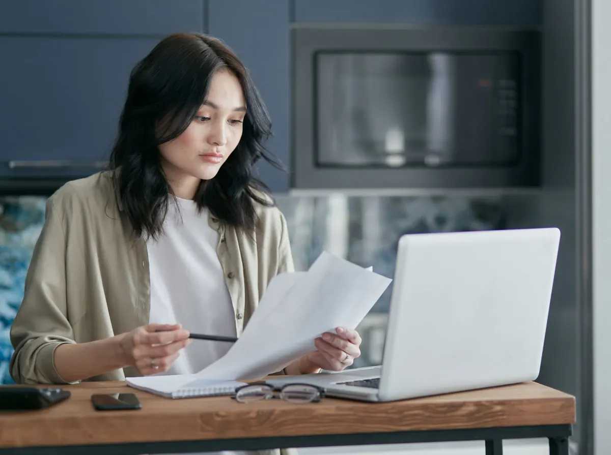 Someone reads through a policy document on a laptop, the kind of review privacy questions call for.