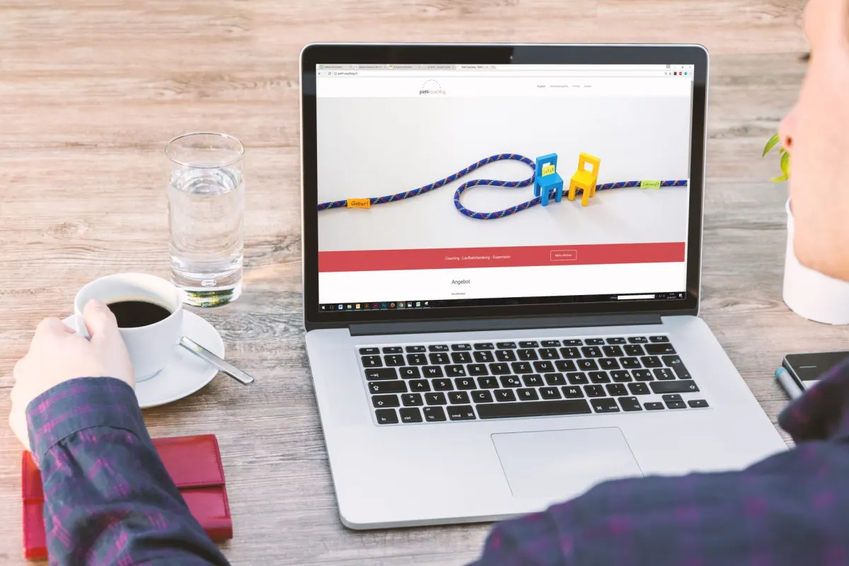 A marketer reviews traffic charts on a laptop while comparing analytics tools.