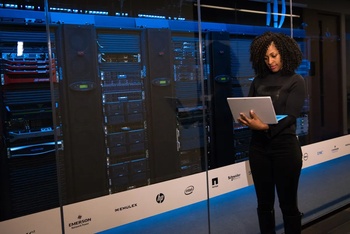 A developer inspects server hardware, evoking the self-hosting and data-control choices behind a testing plan.