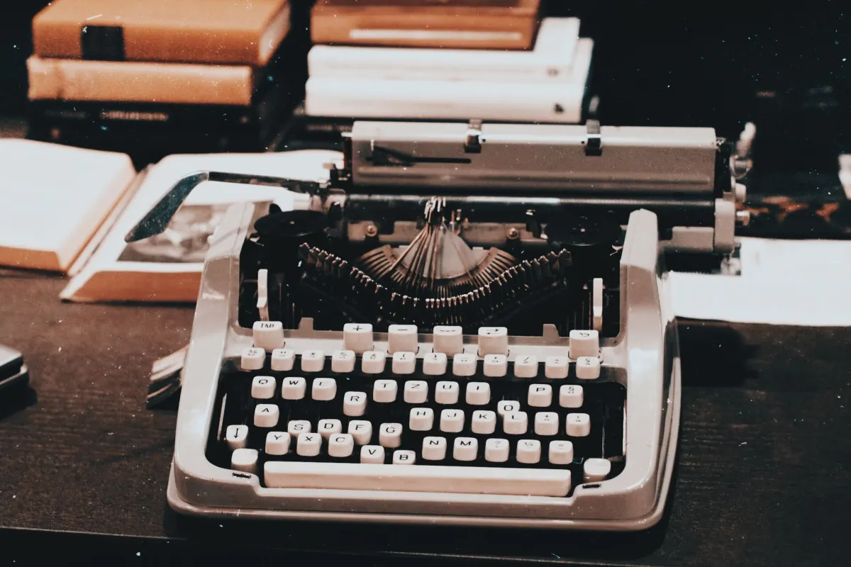 A writer types at a desk, illustrating the work of drafting a page an AI Overview can quote.