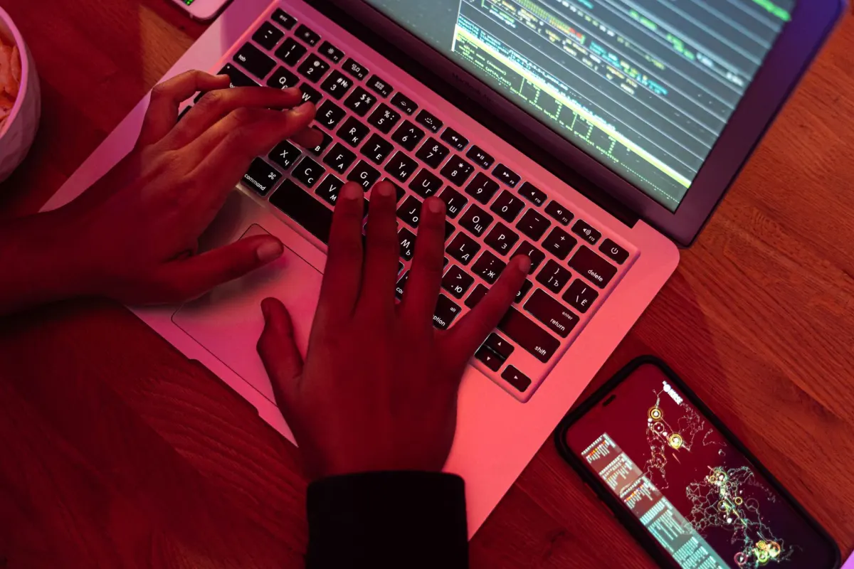 A person typing code at a laptop late at night, evoking the researchers and moderators who query Reddit archives.