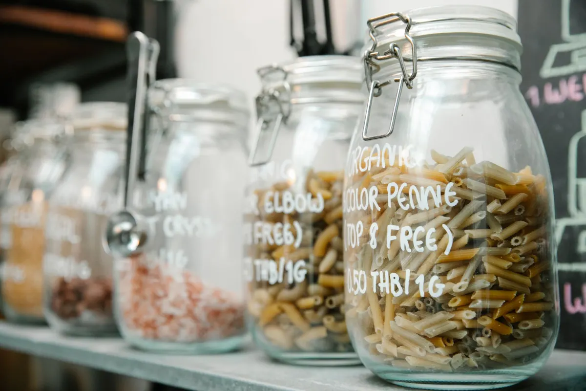 Rows of glass jars with handwritten paper labels, a picture of how a short label value tags content without changing it.