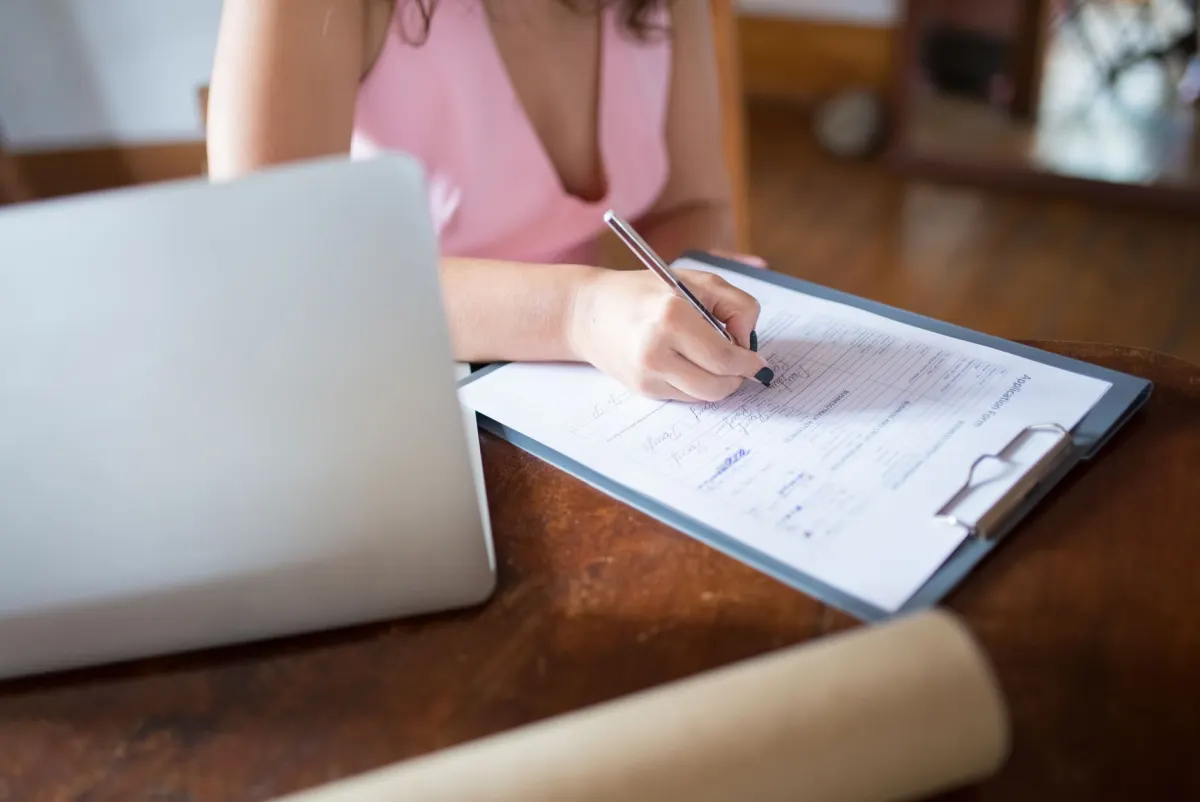 A person fills out a sign-up form on a laptop, the moment a self-reported attribution question would appear.