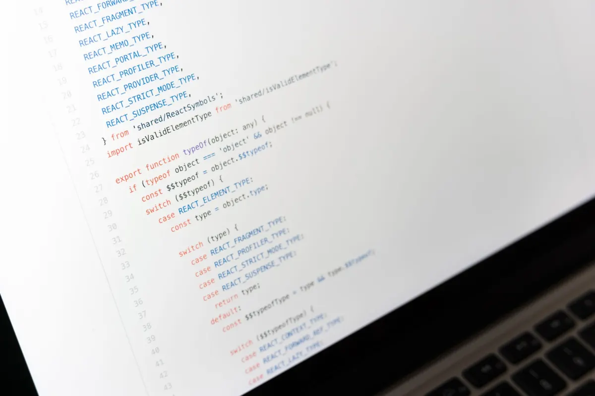 A developer's hands on a laptop keyboard, next to the section on whether Reddit's robots.txt permits crawling.