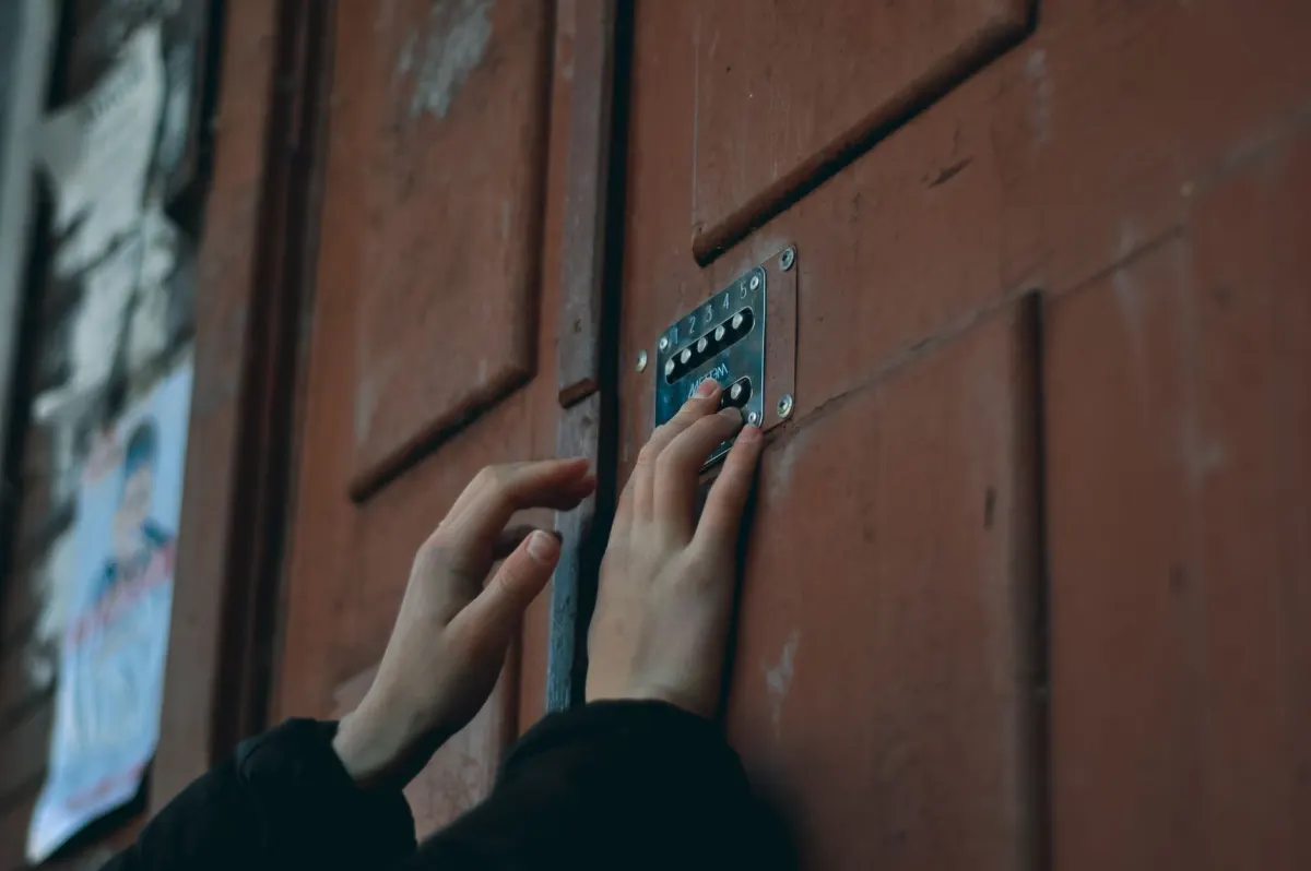 A hand held back from a locked door, standing for the limits a Cue agent needs so it never replies, contacts anyone or holds your X login.