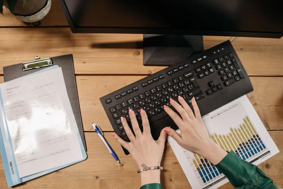 A person calculates a margin of error on a laptop spreadsheet, next to the section on computing your own confidence interval.
