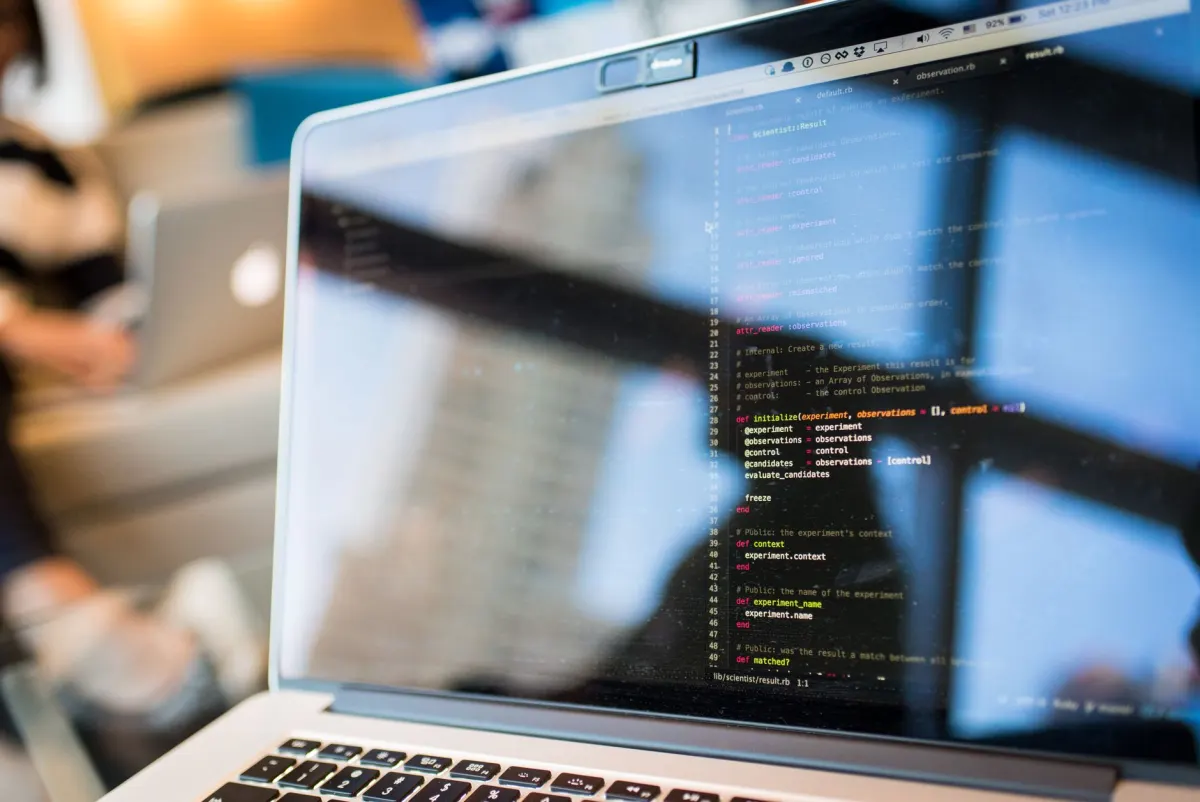 A developer working at a laptop, next to the section on how teams monitoring X manage the cost.